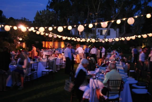  garden space with alternating white paper lanterns above all the tables