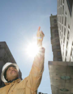 Construction man pointing at a building